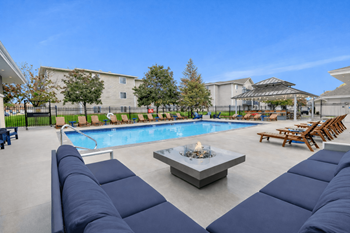 Pool area with fire pit and lounge seating